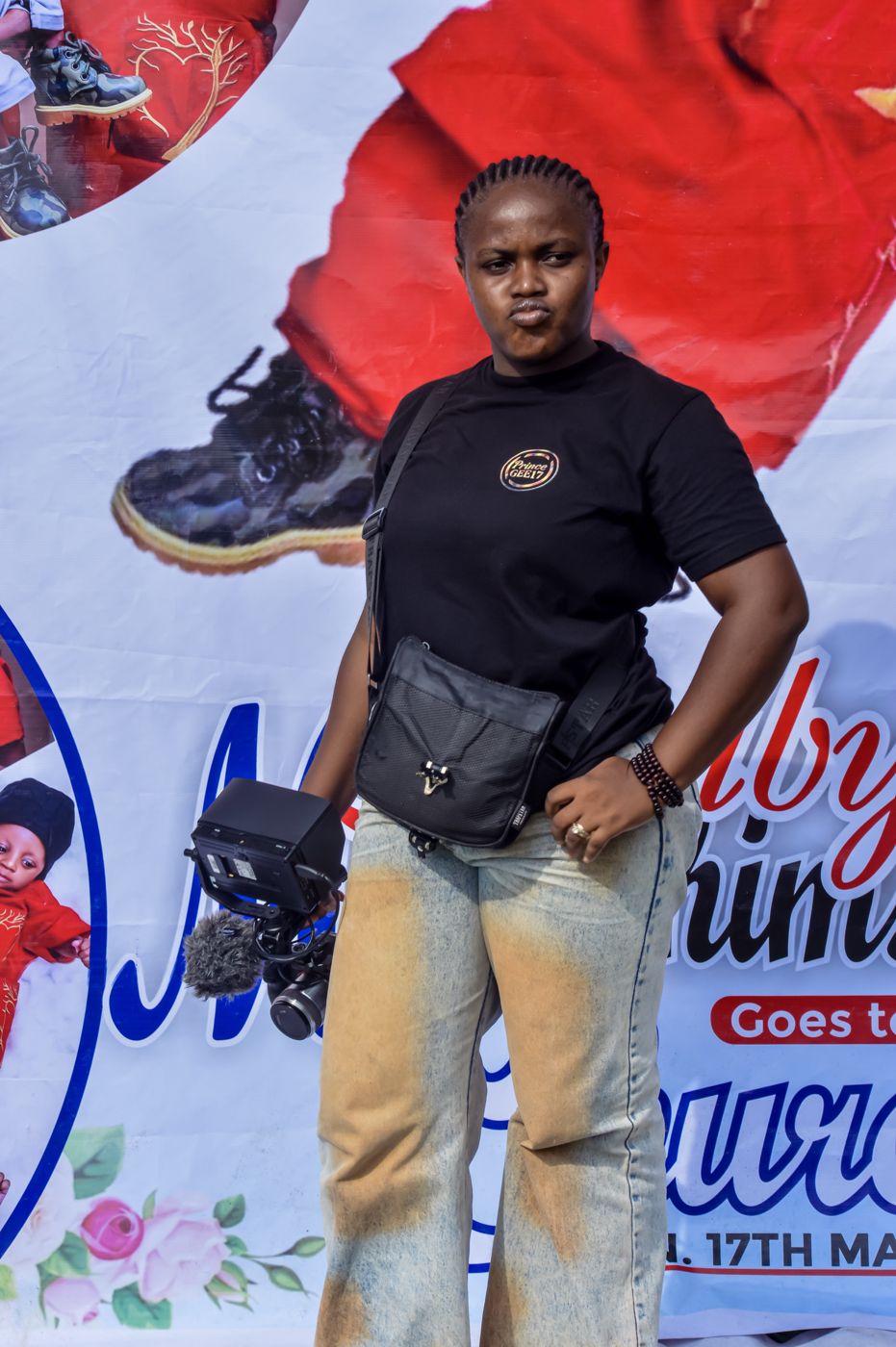 Prince GEE17 crew member with camera monitor and microphone at an event